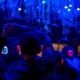 a group of people attend a silent disco wearing light up headphones